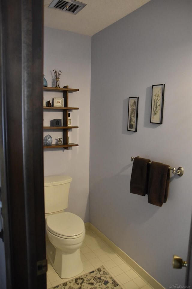 bathroom with tile patterned floors, visible vents, baseboards, and toilet