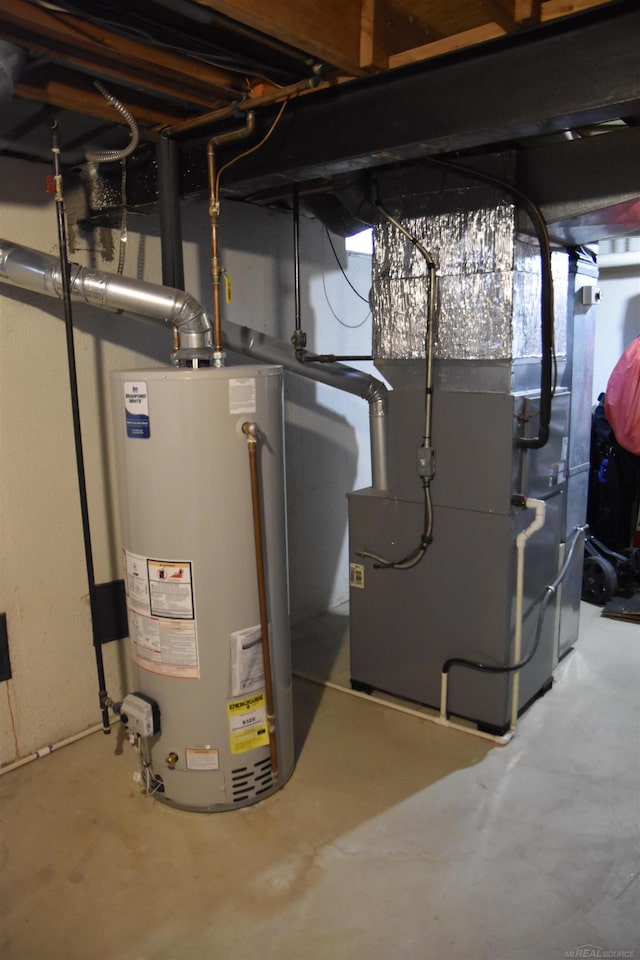 utility room featuring heating unit and water heater