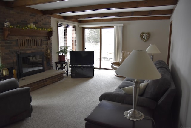 carpeted living area featuring beamed ceiling and a brick fireplace