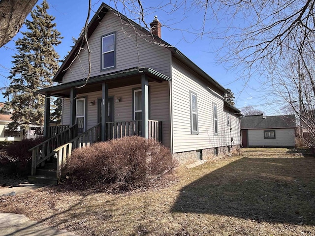 view of front of house with covered porch and a chimney