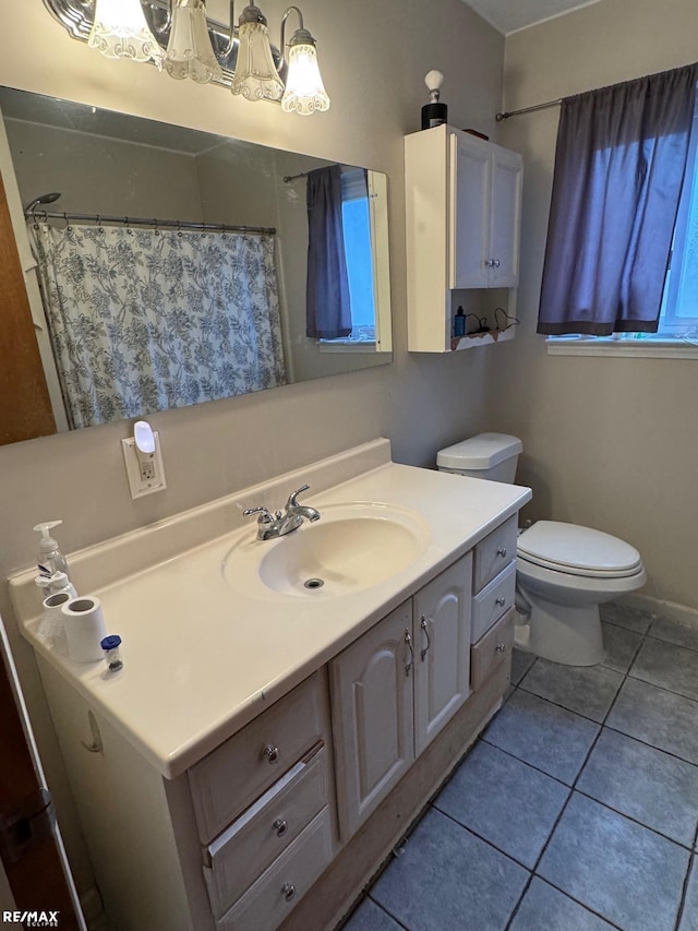 full bath featuring tile patterned flooring, a shower with curtain, toilet, and vanity