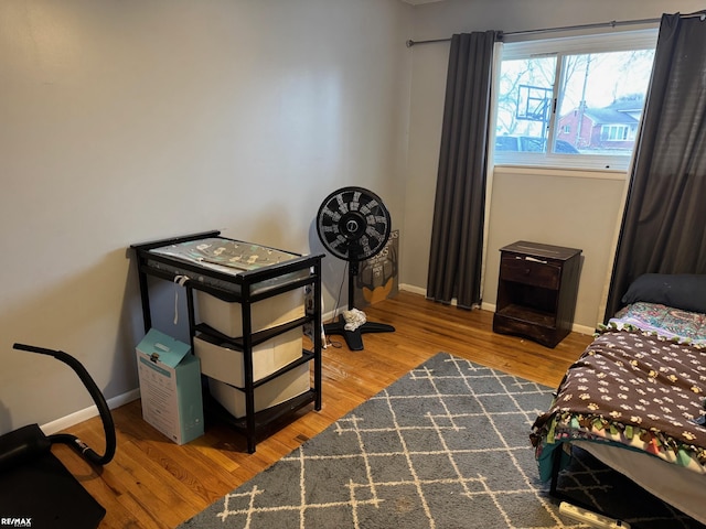 bedroom featuring baseboards and wood finished floors