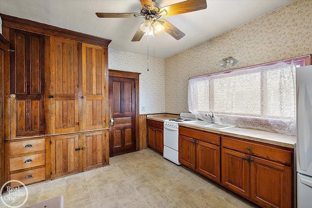 kitchen with brown cabinetry, white appliances, wallpapered walls, and light countertops