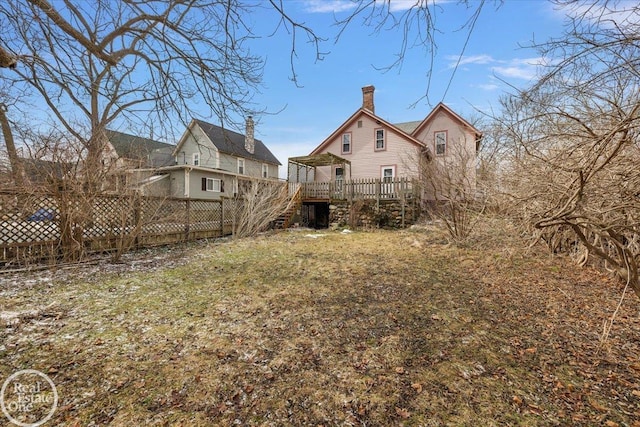 view of yard with fence and a wooden deck