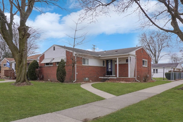 bungalow-style home featuring brick siding, a front lawn, and fence