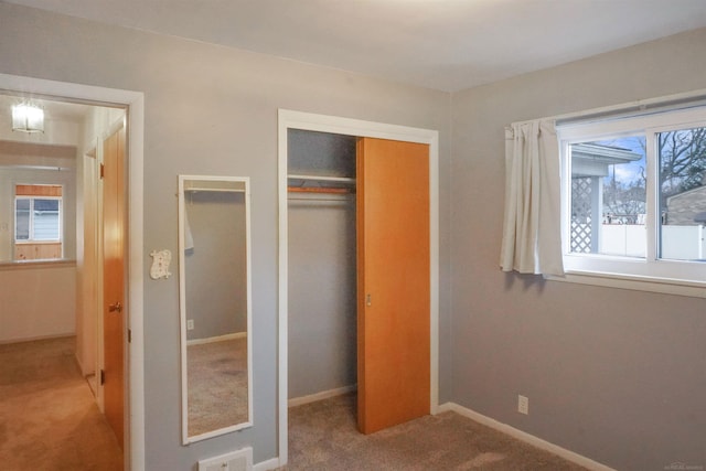 unfurnished bedroom featuring visible vents, baseboards, a closet, and carpet flooring