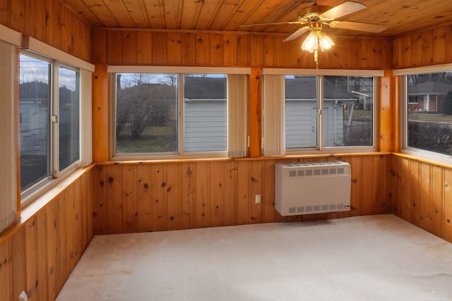 unfurnished sunroom with heating unit, wooden ceiling, and a ceiling fan