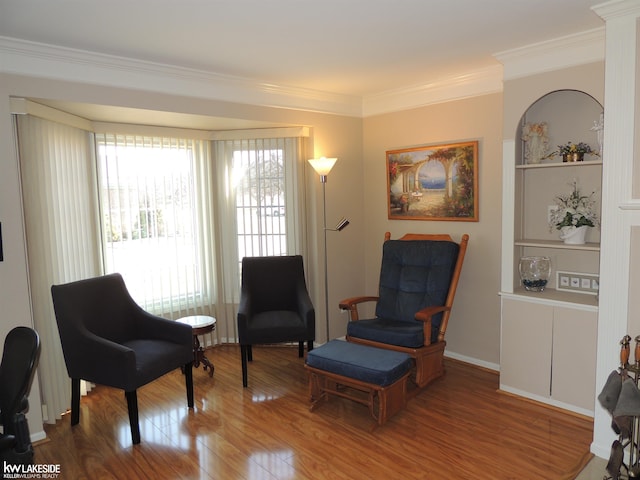 sitting room featuring crown molding and wood finished floors