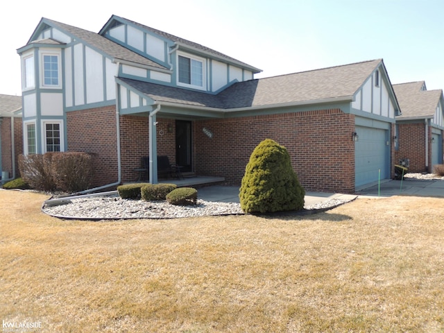 view of side of home featuring brick siding, concrete driveway, roof with shingles, a yard, and a garage