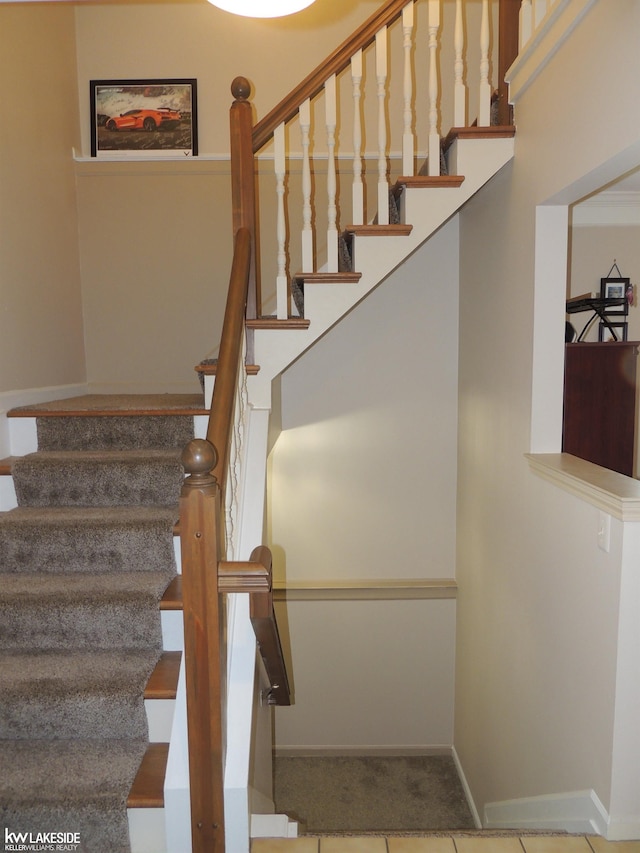 stairway featuring tile patterned floors and baseboards