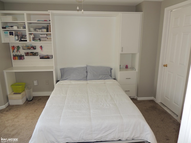 bedroom with carpet and baseboards