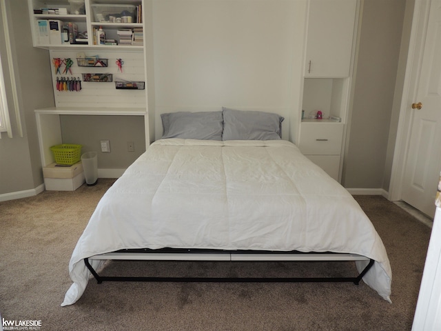 bedroom featuring carpet and baseboards