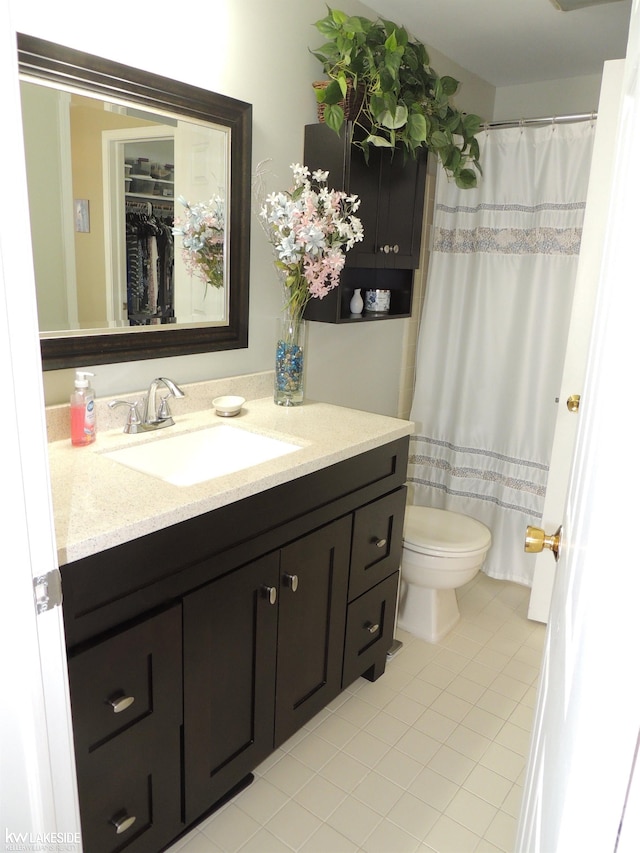 bathroom with vanity, toilet, and tile patterned flooring