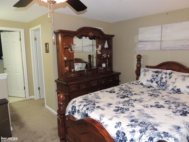 carpeted bedroom featuring baseboards and a ceiling fan