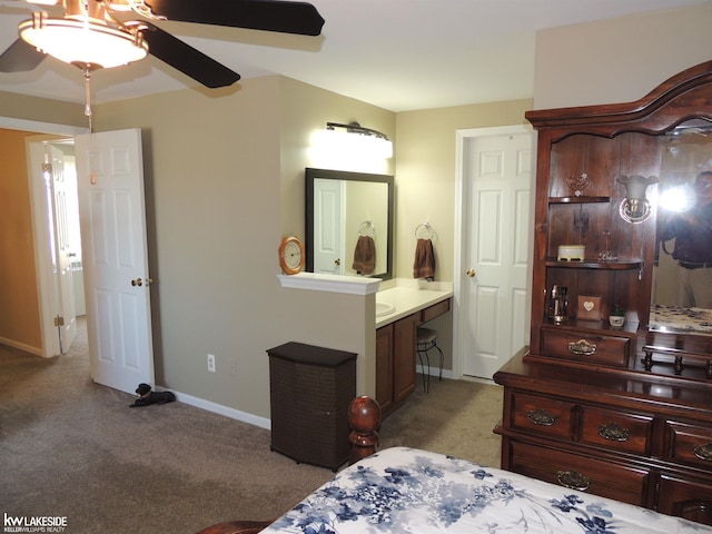 bedroom with light carpet, ensuite bath, baseboards, and a ceiling fan