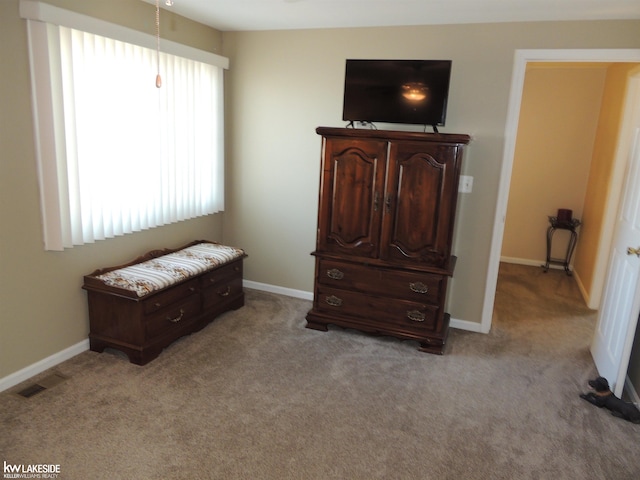 bedroom with visible vents, light colored carpet, and baseboards