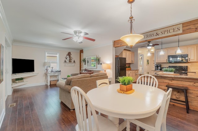 dining room with dark wood-type flooring, a ceiling fan, and ornamental molding