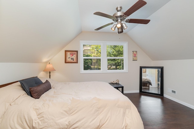 bedroom with dark wood-style floors, visible vents, baseboards, and vaulted ceiling