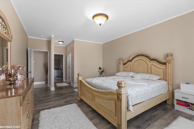 bedroom featuring baseboards, dark wood finished floors, and crown molding