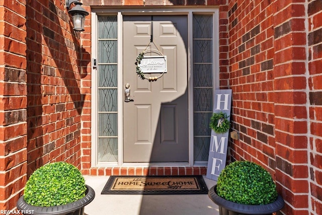 property entrance with brick siding