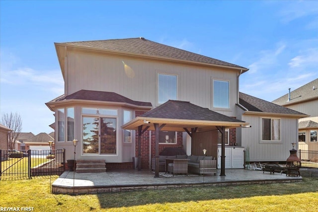 back of house featuring a yard, an outdoor hangout area, a patio, and fence