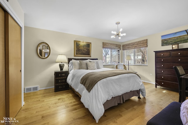 bedroom featuring visible vents, baseboards, a chandelier, and light wood finished floors