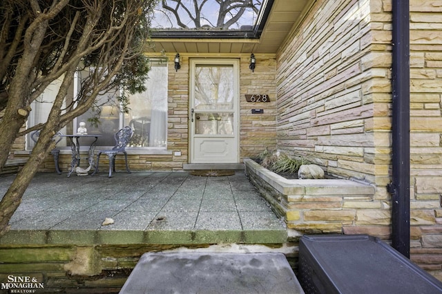 view of exterior entry featuring stone siding