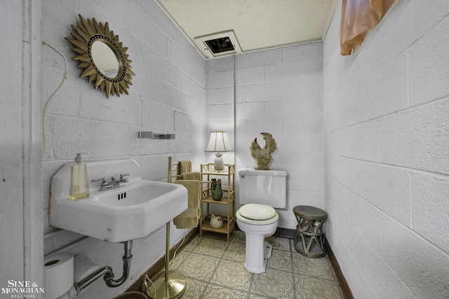 half bath with toilet and tile patterned flooring