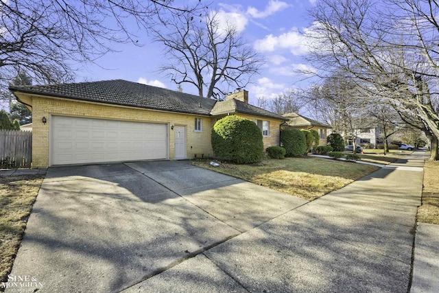 view of front of home with fence, driveway, an attached garage, a chimney, and brick siding