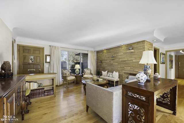 living area with recessed lighting and light wood-style floors