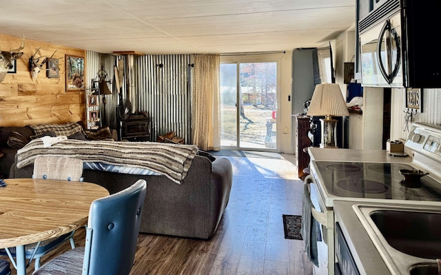 living room featuring wooden walls and hardwood / wood-style floors