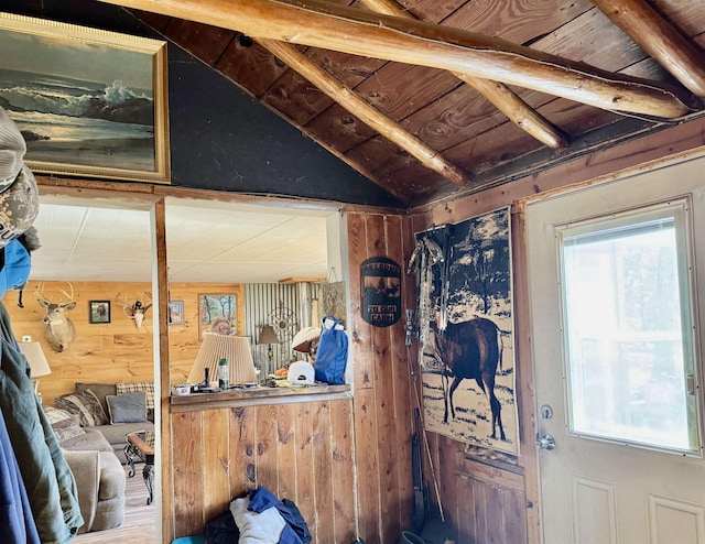 miscellaneous room featuring lofted ceiling, wooden walls, wood ceiling, and a wealth of natural light