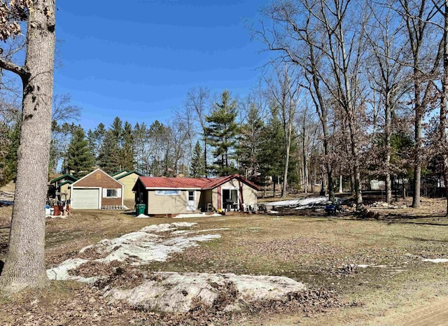 view of front facade with a garage and metal roof