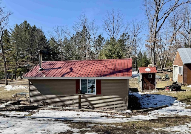 view of snow covered exterior featuring metal roof