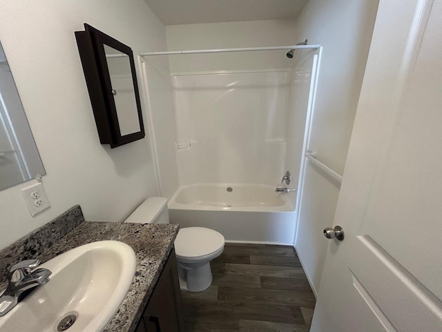 full bath with vanity, washtub / shower combination, toilet, and wood finished floors