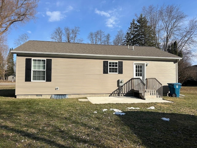 back of property featuring crawl space and a lawn