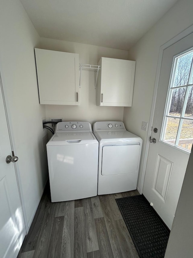 clothes washing area featuring washer and dryer, baseboards, cabinet space, and dark wood-style flooring