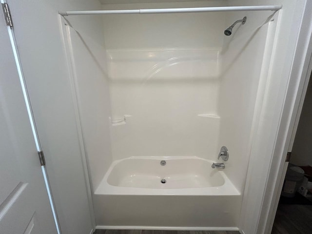 bathroom with bathing tub / shower combination