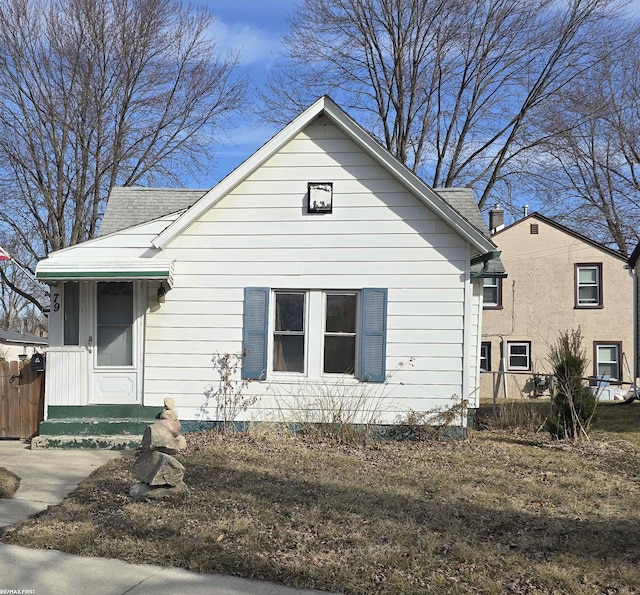 bungalow featuring a shingled roof