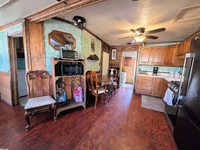 kitchen featuring stainless steel gas range, dark wood finished floors, ceiling fan, light countertops, and black microwave