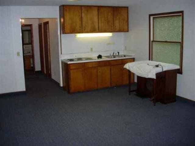 kitchen with brown cabinets, light countertops, and a sink