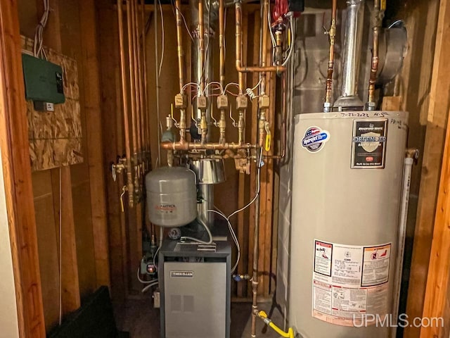 utility room with gas water heater and a heating unit