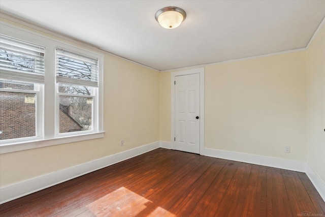 unfurnished room with dark wood-style floors and baseboards