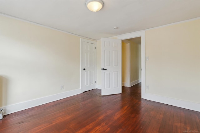 unfurnished room featuring baseboards and hardwood / wood-style flooring