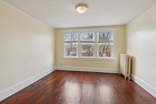 unfurnished room featuring dark wood finished floors, radiator heating unit, and baseboards