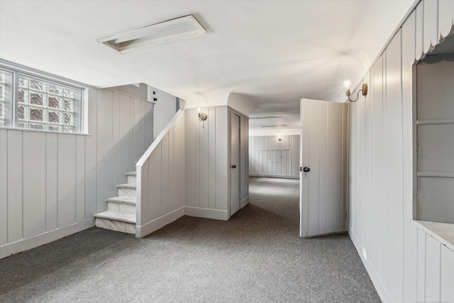 basement with stairs and carpet flooring