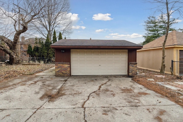 detached garage featuring fence