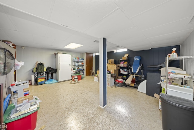 finished basement featuring freestanding refrigerator