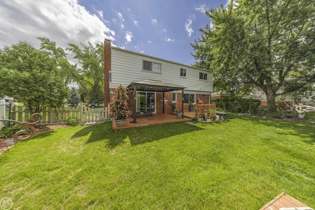 rear view of property featuring a fenced backyard, a gazebo, a deck, a lawn, and brick siding