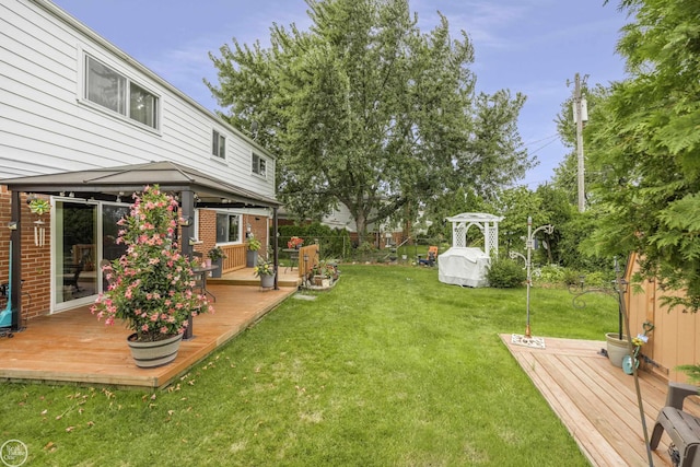 view of yard featuring a deck, a gazebo, and fence